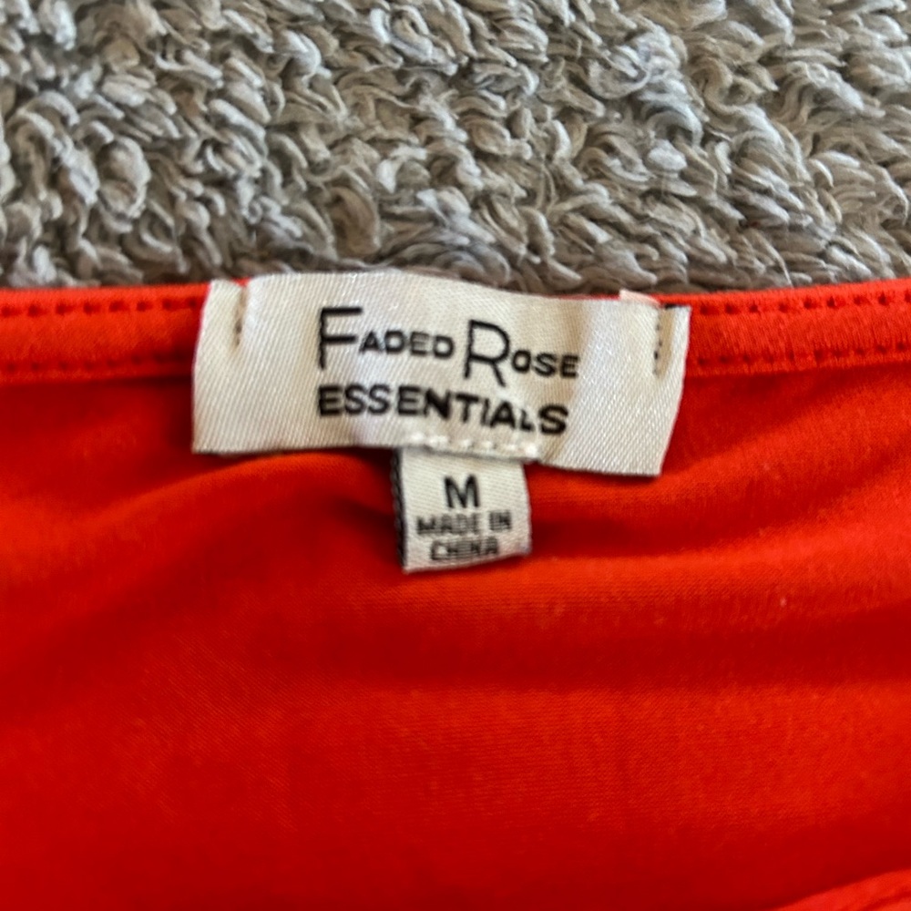 bright orange ish red ish shirt